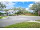 Inviting community entrance with a guard house, landscaped surroundings, and a brick entrance sign at 2900 Grasslands Dr, Lakeland, FL 33803