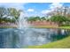 Beautiful fountain in the Grasslands community lake surrounded by lush landscaping and brick entrance signage at 2900 Grasslands Dr, Lakeland, FL 33803