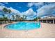 Large community pool with ample seating, and palm tree landscaping at 2900 Grasslands Dr, Lakeland, FL 33803