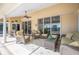 Inviting covered patio with comfortable seating, ceiling fan, and view of the pool at 2900 Grasslands Dr, Lakeland, FL 33803