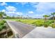 Picturesque view of the golf course with a wooden bridge, mature trees, and green fairways at 2900 Grasslands Dr, Lakeland, FL 33803