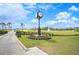 Ornate clock tower on a golf course, surrounded by colorful flowers and lush greenery at 2900 Grasslands Dr, Lakeland, FL 33803