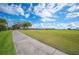 Scenic golf course view from the neighborhood walking path on a sunny day at 2900 Grasslands Dr, Lakeland, FL 33803