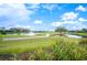 Golf course view featuring a water hazard and fountain at 2900 Grasslands Dr, Lakeland, FL 33803