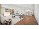 Bright living room featuring hardwood floors, white walls, comfortable seating, and ample space at 2900 Grasslands Dr, Lakeland, FL 33803