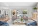 Bright living room features fireplace and large windows, providing a serene indoor-outdoor living experience at 2900 Grasslands Dr, Lakeland, FL 33803