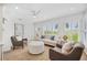 Bright living room with neutral palette and shuttered windows overlooking the outdoors at 2900 Grasslands Dr, Lakeland, FL 33803
