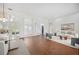 Bright living room featuring hardwood floors, white walls, comfortable seating, and elegant decor at 2900 Grasslands Dr, Lakeland, FL 33803