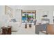 Bright living room featuring hardwood floors, white walls, comfortable seating, and a view of the outdoor pool at 2900 Grasslands Dr, Lakeland, FL 33803