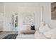 Bedroom includes a cozy bench and a view to the ensuite bathroom and walk in closet at 2900 Grasslands Dr, Lakeland, FL 33803