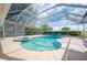Beautiful screened-in pool with attached hot tub and a travertine patio at 2900 Grasslands Dr, Lakeland, FL 33803