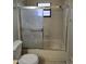 Bathroom featuring toilet and tub with shower and glass doors at 320 Eron Way # 6, Winter Garden, FL 34787