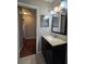 Bathroom featuring dark vanity, sink, and shower at 320 Eron Way # 6, Winter Garden, FL 34787