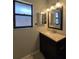 Bathroom featuring dark vanity, mirror, and window at 320 Eron Way # 6, Winter Garden, FL 34787