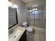 Bathroom featuring shower with glass door, toilet and sink at 320 Eron Way # 6, Winter Garden, FL 34787