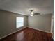 Bedroom with hardwood floors, ceiling fan, neutral paint, window and base molding at 320 Eron Way # 6, Winter Garden, FL 34787