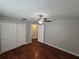 Bedroom with hardwood floors, ceiling fan, neutral paint, and double door closet at 320 Eron Way # 6, Winter Garden, FL 34787