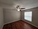Bedroom with hardwood floors, ceiling fan, neutral paint, and a window for natural light at 320 Eron Way # 6, Winter Garden, FL 34787