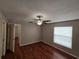 Bedroom with hardwood floors, ceiling fan, neutral paint, and a window for natural light at 320 Eron Way # 6, Winter Garden, FL 34787