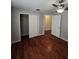 This bedroom features wood floors, ceiling fan and closet at 320 Eron Way # 6, Winter Garden, FL 34787