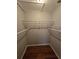 Walk-in closet featuring wire shelving and hardwood floors for efficient storage at 320 Eron Way # 6, Winter Garden, FL 34787