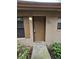 A front exterior door with a cemented walkway entrance to unit 320 at 320 Eron Way # 6, Winter Garden, FL 34787