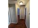Hallway featuring dark hardwood floors and neutral paint, with doors leading to various rooms at 320 Eron Way # 6, Winter Garden, FL 34787