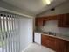 A kitchen with granite countertops, wood cabinets, and a stainless steel sink at 320 Eron Way # 6, Winter Garden, FL 34787