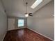 An inviting living room with a skylight, ceiling fan, and hardwood floors at 320 Eron Way # 6, Winter Garden, FL 34787