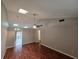 A bright living room with a ceiling fan, skylight, and hardwood floors at 320 Eron Way # 6, Winter Garden, FL 34787
