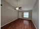 A bright living room showcasing hardwood floors, a ceiling fan and natural light from a window at 320 Eron Way # 6, Winter Garden, FL 34787