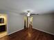 Main bedroom with ceiling fan, ensuite bath, hardwood floors, neutral paint and base molding at 320 Eron Way # 6, Winter Garden, FL 34787