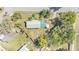 An aerial view of a single Gathering home surrounded by grass and mature trees at 3995 Townley Dr, Mulberry, FL 33860