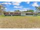 Exterior view showing the home's backyard and screened-in porch at 3995 Townley Dr, Mulberry, FL 33860