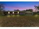 Evening backyard view showing the home's brick and screened-in patio at 3995 Townley Dr, Mulberry, FL 33860