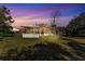 Backyard at sunset showcasing screened-in patio and outdoor space at 3995 Townley Dr, Mulberry, FL 33860