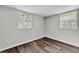 Bedroom with two windows and laminate flooring at 3995 Townley Dr, Mulberry, FL 33860