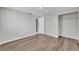 Bedroom with wood-look flooring, a closet, and view of the hall at 3995 Townley Dr, Mulberry, FL 33860