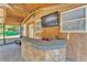 Covered patio space with a bar area, TV, and seating at 3995 Townley Dr, Mulberry, FL 33860