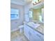 Bathroom features granite countertops, a single sink vanity, a window and tile flooring at 4062 Tullamore Ln, Auburndale, FL 33823
