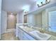 Elegant bathroom with double sinks, granite countertops, and tiled walk-in shower at 4062 Tullamore Ln, Auburndale, FL 33823