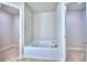 Stylish bathroom showcases a built-in tub framed by dual entryways at 4062 Tullamore Ln, Auburndale, FL 33823