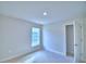 A cozy bedroom with neutral carpet, a window providing natural light, and a door to closet at 4062 Tullamore Ln, Auburndale, FL 33823