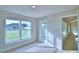 Cozy bedroom with neutral carpet, a backyard view, and a convenient door to the outdoor space at 4062 Tullamore Ln, Auburndale, FL 33823
