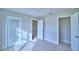 Bright bedroom with neutral carpet and multiple doorways, offering ample space and easy access at 4062 Tullamore Ln, Auburndale, FL 33823