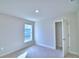 A cozy bedroom with neutral carpet, a window providing natural light, and a door to closet at 4062 Tullamore Ln, Auburndale, FL 33823