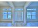 Bright foyer featuring tile flooring and expansive windows, creating a welcoming entrance to the home at 4062 Tullamore Ln, Auburndale, FL 33823