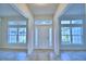 Bright foyer with tile floors, decorative sidelights, and a transom window above the front door at 4062 Tullamore Ln, Auburndale, FL 33823