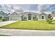 Charming single-story home boasts a well-manicured lawn and inviting curb appeal at 4062 Tullamore Ln, Auburndale, FL 33823