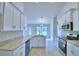 A well-designed kitchen featuring stainless steel appliances and white cabinets at 4062 Tullamore Ln, Auburndale, FL 33823